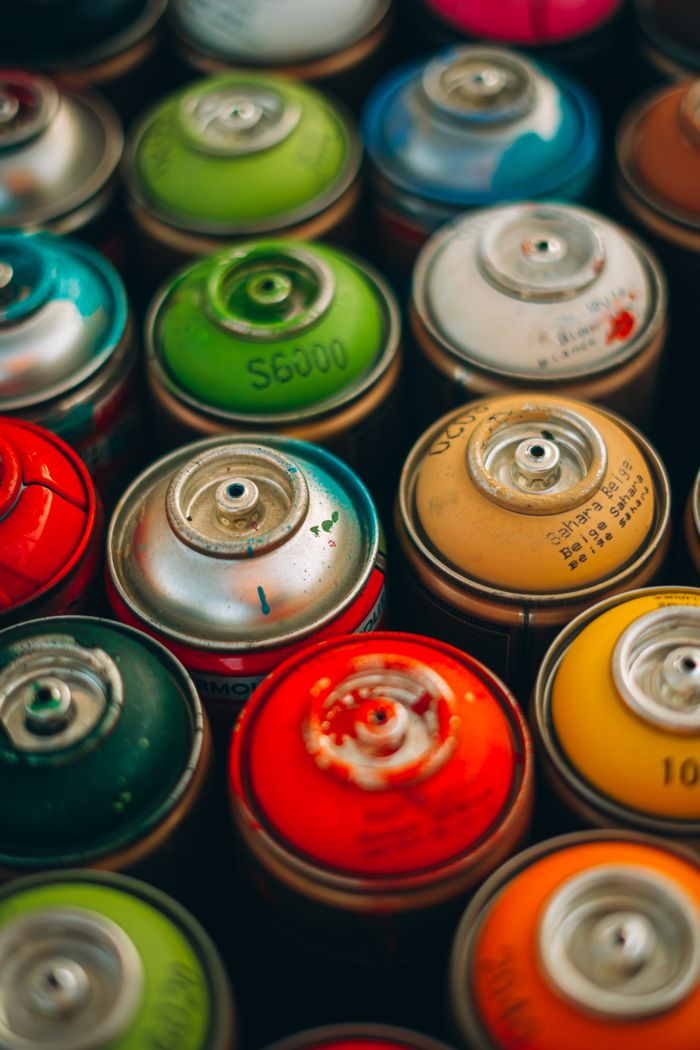 about-01 A vibrant arrangement of spray paint cans showcasing a spectrum of colors.